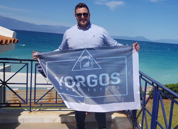 Owner of the comapny Yorgos Real Estate Mr. Yorgos, prodly holding the company flag.